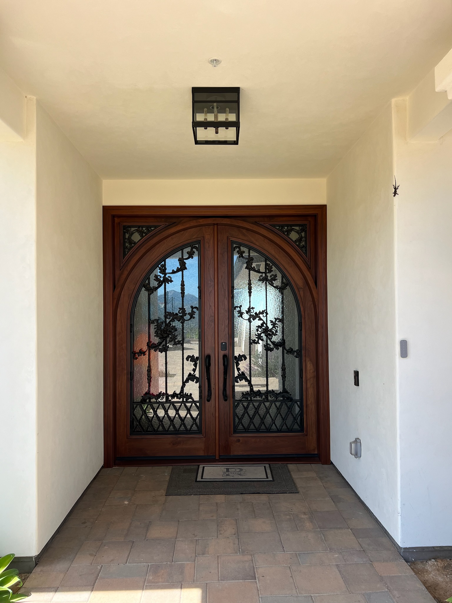 Detailed wrought-iron and wood front door installation